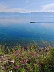 Summer landscape with boat and purple flowers on Circum-Baikal Railway