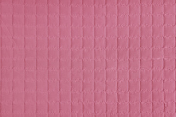 Fototapeta premium Checkered stitching pattern, pink quilted fabric background. Blanket stitch square texture