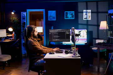 IT engineer fixing vulnerabilities in software enabling hackers to compromise operating system. Cybersecurity professional in apartment using computer to patch security exposures