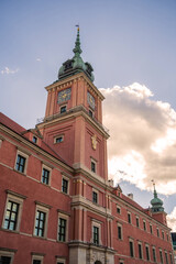 The stunning Royal Castle in Warsaw, featuring its intricate architecture against a backdrop of a vibrant, partially cloudy sky. A perfect representation of historical grandeur and cultural heritage.