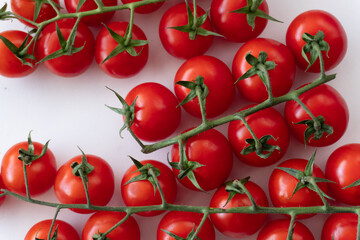 
Background of bright red cherry tomatoes on branches against a white background.
Fresh organic cherry tomatoes in close-up, isolated on a white backdrop. A great option for vegan and raw food dishes.