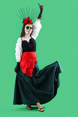 Beautiful woman dressed for Halloween on green background