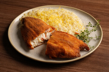 DELICIOUS GOURMET FISH MILANESE STUFFED WITH SHRIMP AND SICILIAN LEMON RISOTTO, STUDIO LIT PHOTOGRAPY TOP VIEW