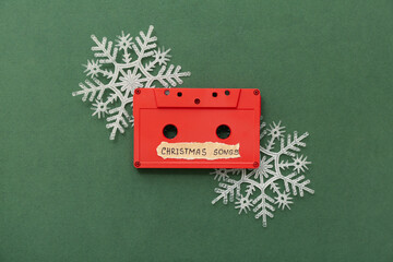 Audio cassette with decorative snowflakes on green background