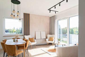 Modern interior of living room with dining room with dining table and chairs. Room with window and luxurious lamp. Home decor.