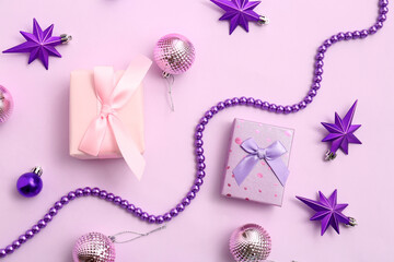 Christmas gift boxes with balls, beads and stars on purple background
