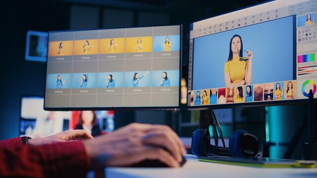 Photo editor editing images, doing color correction in post production company using multi monitor setup, close up. Photographer fixing overexposed pictures on desktop computer retouching software
