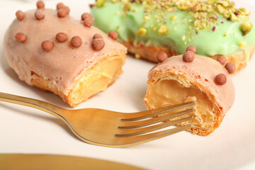 Sweet eclairs on plate, closeup