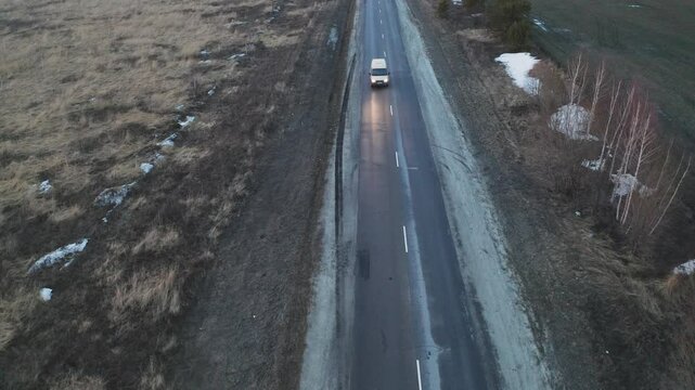 White car overtaking red car on countryside road