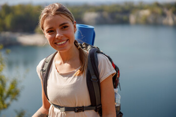 A Young Female Hiker Enthusiastically Exploring the Beautiful Nature Surrounding a Scenic Lake