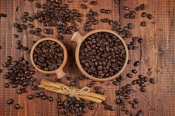 Freshly roasted coffee beans with cinnamon in the foreground