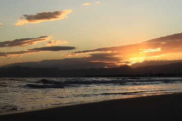 Sunset at sea. Balearic Sea, Salou, Spain. Beach, sea, small waves. Evening landscape on the coast. Vacation at sea