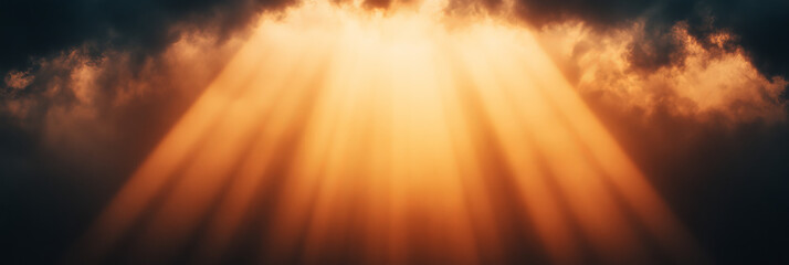 Fototapeta premium Golden rays of sunlight pierce through dark clouds.