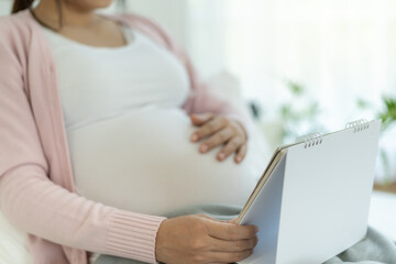 pregnant woman look schedule for due date of birth. Caesarean section is a way for pregnant to know a due date. prepare, newborn, developmental, monitor, appointment, maternity leave, gestational age