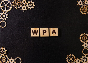 WPA - text concept on wooden cubes with gradient blue background.
