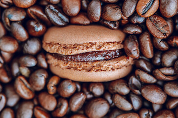 French pastries with coffee cream and aroma.Coffee Desserts.Brown Macarons with Coffee Cream.Macaroons and roasted coffee beans. French Delicious Pastries kit 