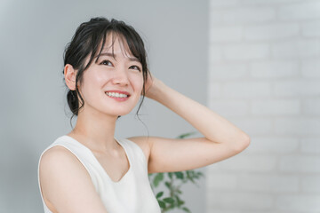 Naklejka premium ビューティ・スキンケア・ダイエットイメージのノースリーブ姿の笑顔のアジア人女性 