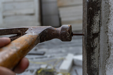 Rusty Hammer and Nail on Wooden Board, Vintage Tool Close-up