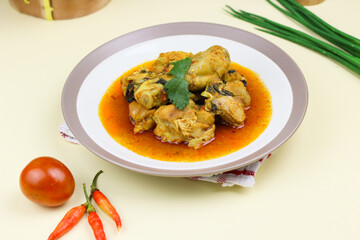 Ayam rica-rica, Indonesian traditional spicy chicken with spicy sauce and basil leaves. Isolated background.
