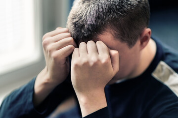 Man with trauma. Teenage boy with shame or anxiety. Sad ashamed victim. Despair, regret or guilt....