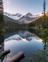 Serene Lake Nestled Between Snow-Capped Peaks and Lush Forests, Reflecting the Sunshine and Surrounding Scenery on Its Glassy Surface During Early Morning