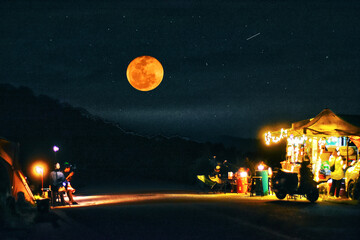 Campsite with moonlit, surrounded by twinkling stars, ideal for peaceful retreats in nature.