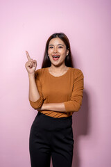 A woman is pointing to the sky with her finger