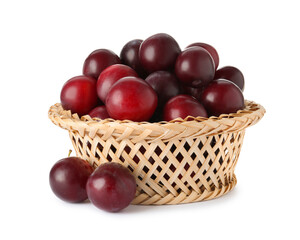 Fresh ripe plums in wicker bowl isolated on white