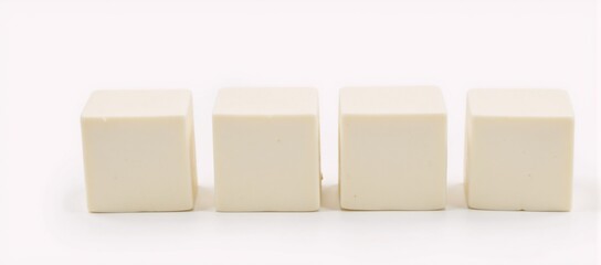 Obraz premium White-background photograph featuring isolated tofu cubes
