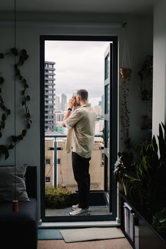 local guy taking a picture of the London cityscape from a balcony