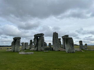 Historic Stonehenge monument in England against a cloudy sky, showcasing ancient stones and landscape.