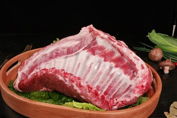 Freshly slaughtered lamb on a table, ribs and thighs, top view