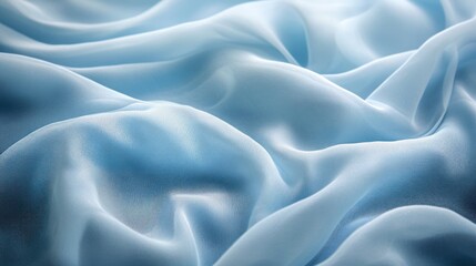 Obraz premium A close-up of soft, flowing blue fabric creating a serene and elegant texture.