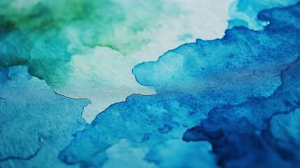 Obraz premium An abstract view of watercolor paper with a vibrant, textured surface, showing a blend of blues and greens.