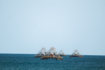 Traditional Bagan Structure Drifting in Serene Ocean Waters. Blue Ocean Meets Sunny Skies. Traditional fish aggregating device, bamboo fish trap.