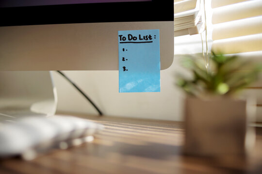 blue sticky note with to do list on Computer at office