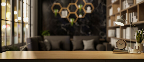 A wooden tabletop set against a blurred background of a modern, elegance black living room.