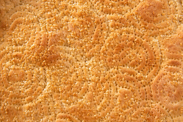 close up of baking naan bread with sesame seeds background.