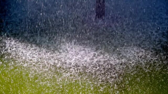 Heavy Water Spray Falling on Pond