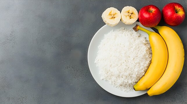 A plain and simple plate of rice bananas and applesauce representing a bland diet for managing and relieving gastritis symptoms and stomach discomfort