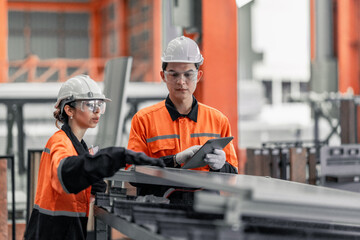 Factory metal workers install solar panels, cut costs, earn carbon credits, combat climate change.