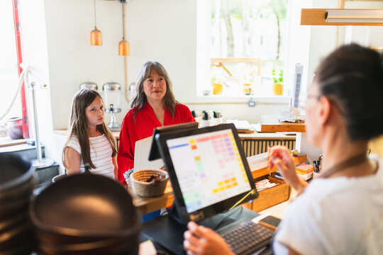 Mother and Daughter Ordering at Cash Register in Korean Restaurant
