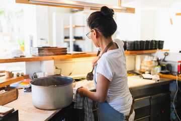 Back View of Korean Chef Preparing Rice in Restaurant Kitchen

