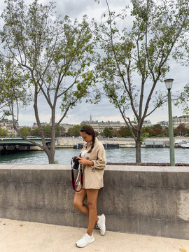 tourist woman in paris checking her photo camera