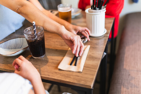Person Placing Napkin for Customer at restaurant