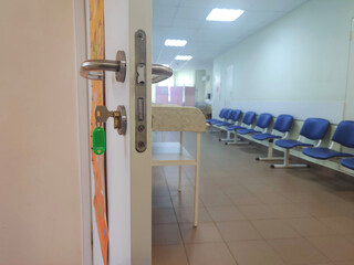 Empty corridor in hospital with chairs. Hospital hallway.	