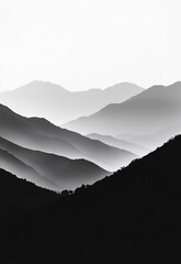A black and white photograph showcasing a stunning view of mountain silhouettes against a misty backdrop © AVADA