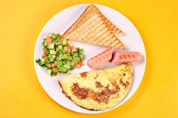 Breakfast Plate with Eggs, Vegetables, and Sausages