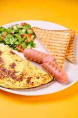 Breakfast Plate with Eggs, Vegetables, and Sausages