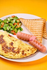 Breakfast Plate with Eggs, Vegetables, and Sausages